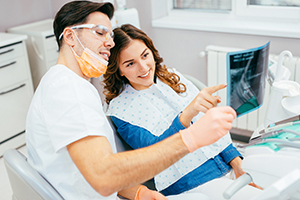Dentist and patient looking at a dental x-ray.